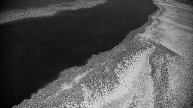 Monochrome aerial landscape showing Queensland ocean waters and intricate natural reef formations - Powered by Adobe