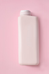 Cosmetic bottle on pink