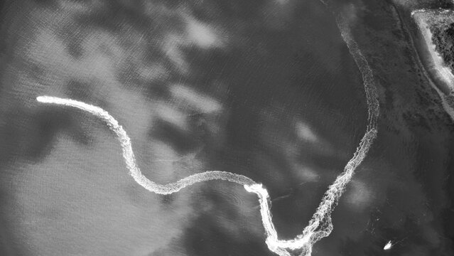 Monochrome aerial view of Queensland coastline showing ocean shapes and striking abstract formations