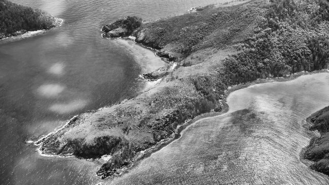 Monochrome aerial view of Queensland coastline showing ocean shapes and striking abstract formations - Powered by Adobe