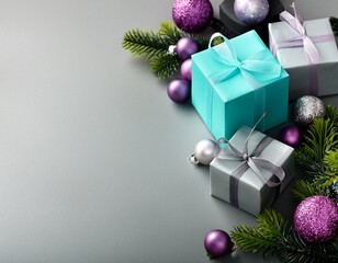 Gray and turquoise gift boxes on gray background with copy space with lilac and silver glass balls and holly branches. Christmas concept