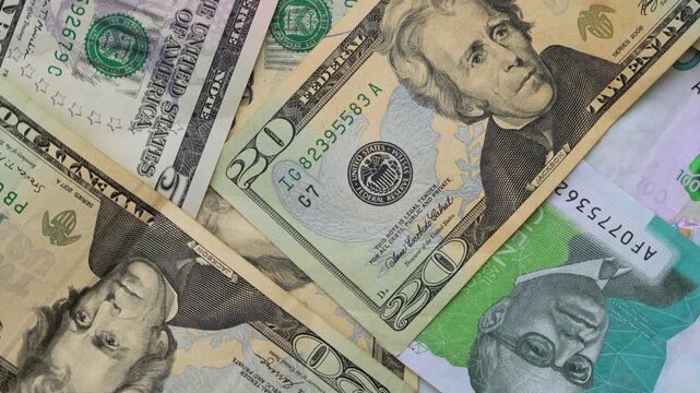 Detailed view of US dollars and Colombian pesos currency notes showcasing vibrant colors and intricate designs. Perfect for finance, business visuals. Lighting highlights textures.