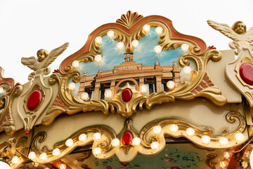 Fototapeta premium Carousel with colorful horses on Christmas fair on Red Square in Moscow. Merry-go-round. The concept of Christmas holidays and school holidays. Christmas winter market