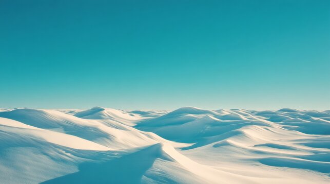 Vast winter landscape with snow dunes creating a serene, cold, and minimalist arctic desert under a clear blue sky