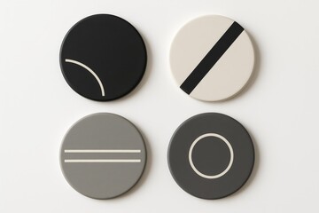Set of four round coasters with minimal black, white and grey geometric designs on white background, modern table accessories.