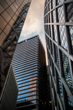 Reflections and verticality define architecture in La Defense, paris as modern towers shape a corporate skyline tied to business and urban finance