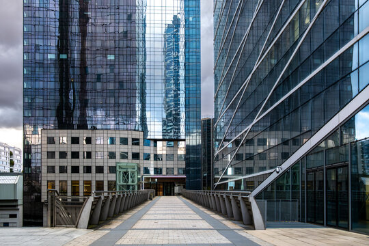 Corporate architecture in La Defense, paris shows modern towers, reflections and verticality forming a skyline linked to business and urban finance