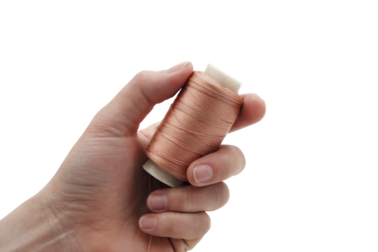 hand holding spool of thread. Isolated on transparent background, png