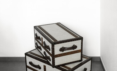 Vintage storage trunks with leather straps and canvas texture in minimal corner room,Minimalist Stack of old style box gift showing retro interior design, home decor, and stylish organization solution