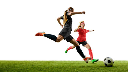 Female football player leaping to shoot ball with determined emotion. Concept of peak action, sports branding, youth development, performance training, agility drills.