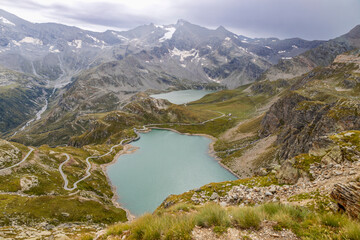 View from the Nivolet hill, the Alpine pass in the Graian Alps from Piedmont and Aosta Valley in the Gran Paradiso National Park with Agnel and Serr&ugrave; lakes, Italy