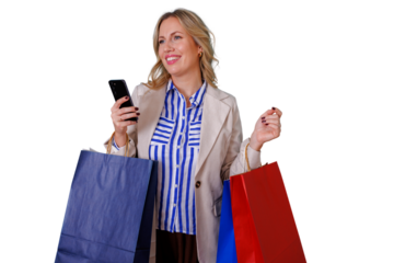 Happy woman holding shopping bags and mobile phone while making online purchases or checking sales, transparent background