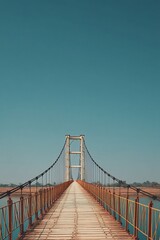 Fototapeta premium Impressive suspension bridge spanning over a tranquil body of water with clear high-resolution detail