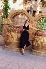 portrait of beautiful woman in sunglasses looking at camera