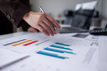 Hand og Many charts and graphs. Reflection light and flare. Concept image of data gathering and statistical working.