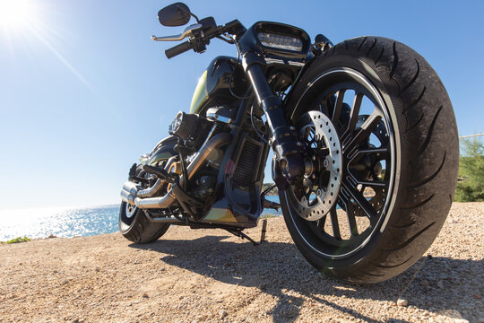 Custom motorcycle by scenic coastal view