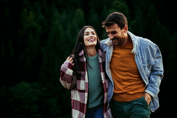 Happy couple walking, laughing, enjoying a romantic relationship