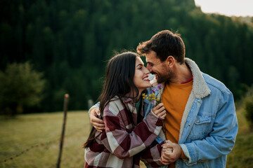 Happy couple hugging enjoying love in nature
