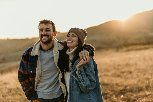 Happy couple enjoying outdoor walk during sunset