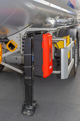 Fire Extinguisher in Box at Landing Gear of Semi Truck Tanker Cargo Trailer