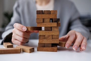 Abstract business woman fail danger tower block game building construction protect plan and project control.
