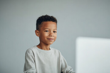 child is engaged in learning programming through captivating aipowered game fully focused at their computer