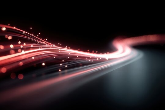 Abstract red light trails with glowing motion across a dark background