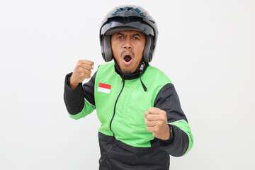 Angry Asian online driver in green jacket standing while showing fist hand. Isolated on white background