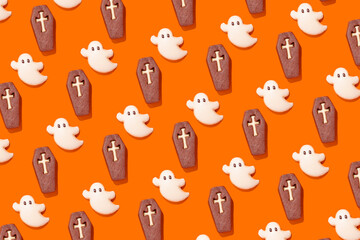 Halloween themed ghost and coffin cookies on orange
