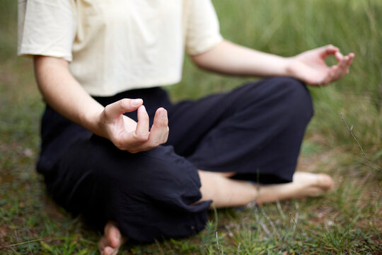 Woman practicing meditation in a serene forest setting