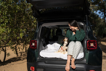 Woman camping with her dog in Portugal nature