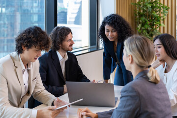 African woman sale manager is showing annual report chart to her colleagues in the executive meeting for next year plan with market share increase for global business and investment
