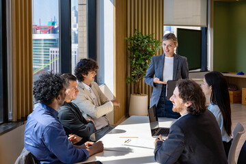 Caucasian woman sale manager is showing annual report chart to colleague in executive meeting for...