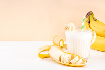 Sweet and tasty traditional korean banana milk. Korean banana uyu, banana flavored non-dairy milk or condensed milk with honey on white table copy space