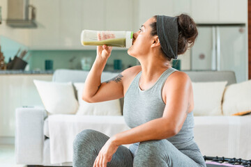 Woman enjoying a healthy green smoothie at home