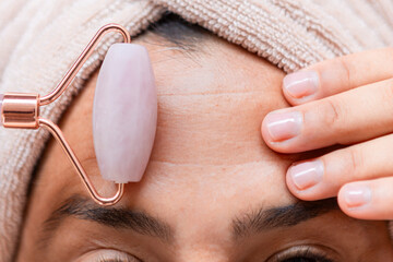 Rose quartz jade roller for facial skin care and wellness