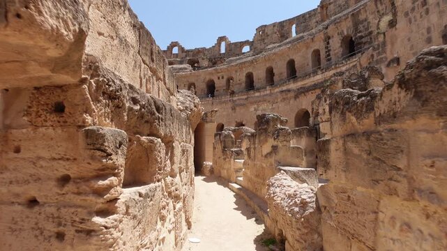 Tunisia history and architecture, walking through corridor inside the massive El Jem Amphitheatre, an important landmark and popular tourist destination
