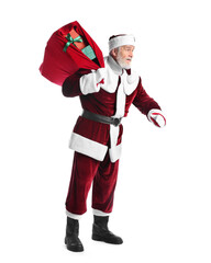 Santa Claus with red bag of Christmas gifts on white background
