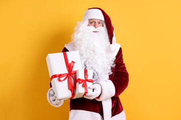 Santa Claus with Christmas gifts on orange background
