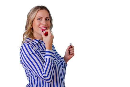 Young woman applying red lipstick, smiling, highlighting her beauty routine and self-confidence. Transparent background for easy use