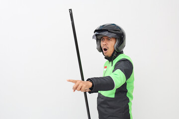 Angry asian online taxi driver man shouting while holding a stick