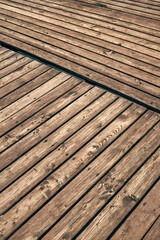 Fototapeta premium Closeup texture of wooden pier boards with natural grain and weathered surface pattern.