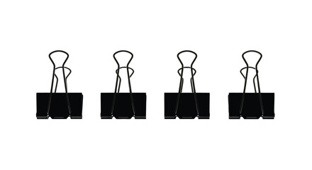 Four black binder clips for office supplies