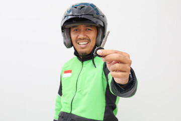Excited asian online driver taxi standing while showing his motorcycle key