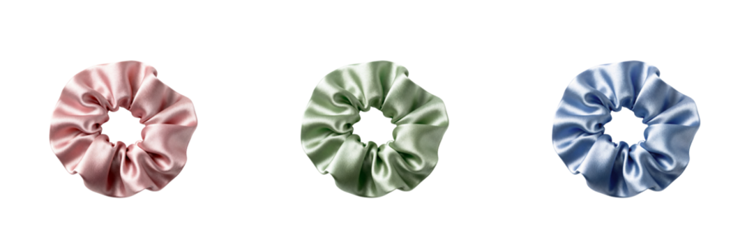 Set of three satin scrunchies in pastel colors on a transparent background