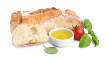 Tasty baguette, oil, tomato and basil isolated on white