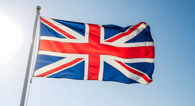 United Kingdom flag waving in the bright blue sky