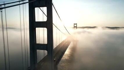Golden Gate Bridge Emerging from Ethereal Fog at Sunrise, Aerial Perspective of San Francisco Bay - Powered by Adobe