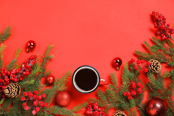 Flat lay composition with cup of aromatic coffee, fir tree branches and Christmas decor on red...