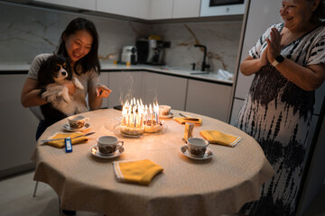 Woman celebrates birthday with family and dog